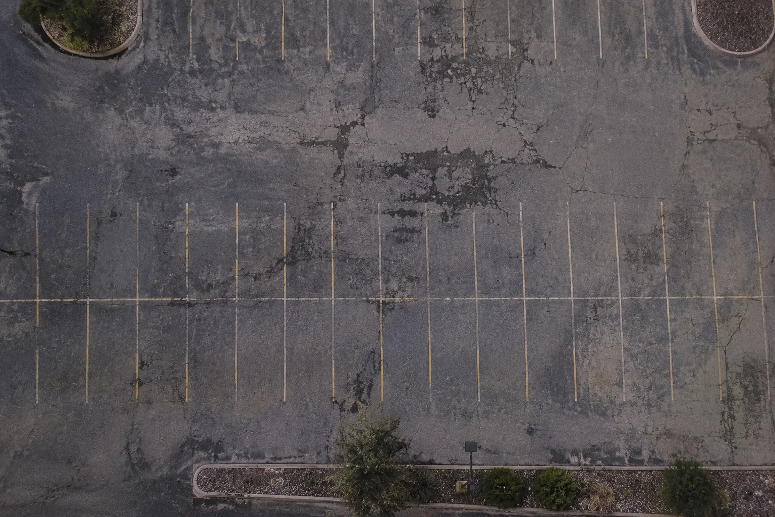 Faded, worn-out parking lot before striping
